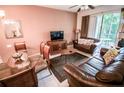 Comfortable living room with leather sofas, dining area, and natural light from sliding doors at 2788 Almaton Loop # 202, Kissimmee, FL 34747