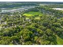 Aerial view of residential neighborhood with mature trees and green spaces at 2827 Park Meadow Dr, Apopka, FL 32703