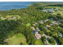 Beautiful aerial view of lakeside homes surrounded by lush greenery and mature trees at 2827 Park Meadow Dr, Apopka, FL 32703