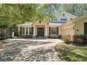 Charming home featuring brick driveway, manicured lawn, double doors and a two car garage at 2827 Park Meadow Dr, Apopka, FL 32703