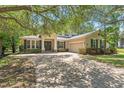 Charming home featuring brick driveway, manicured lawn, double doors and a two car garage at 2827 Park Meadow Dr, Apopka, FL 32703