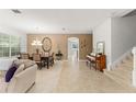 Bright living and dining area features neutral walls and floors, with views into the kitchen at 2827 Park Meadow Dr, Apopka, FL 32703