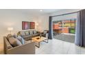 Bright living room features tile floors, comfortable seating, and sliding doors to the patio at 3001 Red Ginger Rd, Kissimmee, FL 34747