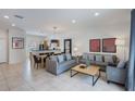 Open-concept living area with tile flooring, comfortable sofas, and access to the dining area at 3001 Red Ginger Rd, Kissimmee, FL 34747