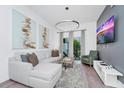 Stylish living room featuring contemporary decor, comfortable seating, and a sleek entertainment setup for modern living at 348 Famagusta Dr, Davenport, FL 33896