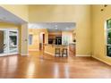 Open-concept living room and kitchen with hardwood floors and large windows offering plenty of natural light at 4107 Gabriella Ln, Winter Park, FL 32792