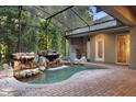 Beautiful screened-in pool with a rock waterfall and lush greenery, great for outdoor entertainment at 4107 Gabriella Ln, Winter Park, FL 32792