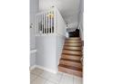 A charming entryway features wood stairs and a white railing, leading to the upper level of the home at 425 Eagle Ridge Dr # 425, Davenport, FL 33837