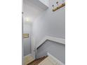 A charming staircase with wooden steps and a white railing leads to the upper level at 425 Eagle Ridge Dr # 425, Davenport, FL 33837