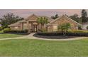 Charming single-story brick home featuring a manicured lawn and inviting walkway leading to the front door at 441 Hightower Dr, Debary, FL 32713