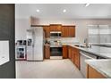 Bright kitchen featuring stainless steel appliances, granite countertops, and tiled flooring at 4558 Redmond Pl, Sanford, FL 32771