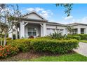 Beautiful home with lush landscaping, a charming porch, and a bright exterior at 5013 E Fountainwood Dr, St Cloud, FL 34772