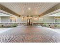 Covered entrance featuring brick paving, double doors, and decorative lighting at 5655 Oak Hollow Ln, Oviedo, FL 32765