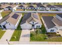 Aerial view of a single Gathering home with solar panels in a residential neighborhood at 6984 Dilly Lake Ave, Groveland, FL 34736