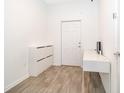 Bright entryway featuring a storage unit, desk, and a white front door at 6984 Dilly Lake Ave, Groveland, FL 34736