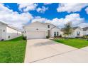 Inviting one-story home with a spacious driveway and lovely landscaping at 6984 Dilly Lake Ave, Groveland, FL 34736