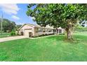 Well-maintained single-story home featuring an attached garage and mature landscaping at 701 Lakeshore Blvd, St Cloud, FL 34769