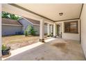 Open carport with concrete flooring and support columns, providing covered parking and access to the home's entrance at 718 Wildwood Dr, Winter Springs, FL 32708