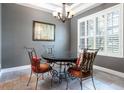 Formal dining room with tile floors, chandelier, and a window with plantation shutters at 804 Challis Pt, Longwood, FL 32779