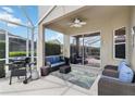 Outdoor patio with comfortable seating and a grill, ideal for entertaining at 822 Brunello Dr, Davenport, FL 33897