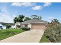 Lovely single-story home offering a well-kept lawn, landscaped front, and a convenient two-car garage at 842 Amidon St, Deltona, FL 32725
