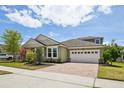 Charming single-Gathering home with a well-manicured lawn, beautiful landscaping, and a brick-paved driveway at 8420 Corkfield Ave, Orlando, FL 32832