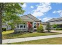 Beautiful single-Gathering home with a landscaped front yard and a welcoming porch with decorative columns at 8420 Corkfield Ave, Orlando, FL 32832