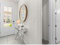 Bright and welcoming foyer with a stylish mirror and console table, leading into the home's interior at 8943 Coconut Breeze Dr, Kissimmee, FL 34747