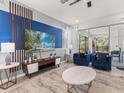 Comfortable living room with modern decor, a large TV, and sliding doors that open to the outdoor area at 8943 Coconut Breeze Dr, Kissimmee, FL 34747