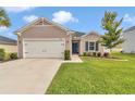Inviting front exterior with a well-maintained lawn and mature landscaping, showcasing the home's curb appeal at 9262 Sw 58Th Cir, Ocala, FL 34476
