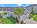 Side view of the home showing a palm tree, a well-kept lawn, and a fenced yard at 9262 Sw 58Th Cir, Ocala, FL 34476