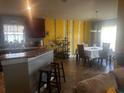 Inviting kitchen featuring a breakfast bar, stainless appliances, and views to the dining area at 1185 Sabine Ln, Kissimmee, FL 34759