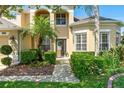 Inviting entrance with meticulously manicured front yard, stone walkway, and stylish front door at 10160 Mallard Landings Way, Orlando, FL 32832