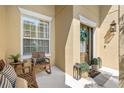 Charming front porch with comfortable seating, stylish decor, and elegant front door with wreath at 10160 Mallard Landings Way, Orlando, FL 32832