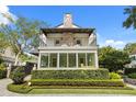 Charming two-story home featuring a balcony, manicured lawn, and brick accents at 104 Cortland Ave, Winter Park, FL 32789