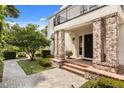 Inviting front entrance with brick columns, landscaped garden, and stone walkway at 104 Cortland Ave, Winter Park, FL 32789