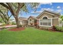 Lovely single-story home with green lawn and American flag at 1040 Big Oaks, Oviedo, FL 32765