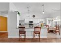 Bright kitchen features granite counters, stainless appliances, and seating at breakfast bar at 1040 Big Oaks, Oviedo, FL 32765