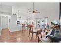 Open-concept living space with hardwood floors, vaulted ceilings, and access to outdoor patio at 1040 Big Oaks, Oviedo, FL 32765