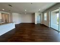 Spacious living room with hardwood floors, sliding glass doors, and recessed lighting at 1141 Lakeshore Breeze Pl, Kissimmee, FL 34747