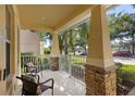 Inviting front porch featuring stone pillars and cozy seating, perfect for relaxing outdoors at 1286 Tallow Rd, Apopka, FL 32703