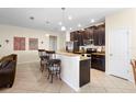 Eat-in kitchen with granite countertops, dark wood cabinets, and stainless steel appliances at 1286 Tallow Rd, Apopka, FL 32703
