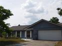 A single-story home with a one-car garage and a well-maintained lawn at 130 Krider Rd, Sanford, FL 32773