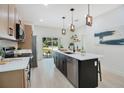 Contemporary kitchen featuring a large island with sink, bar stool seating, and ample counter space at 1371 Lake Dr, Casselberry, FL 32707