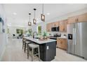 Modern kitchen with stainless steel appliances, island with seating, and open floor plan at 1371 Lake Dr, Casselberry, FL 32707