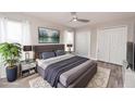 Comfortable staged bedroom with neutral tones, plush bedding, ceiling fan, and closet space at 139 Randle Ave, Oak Hill, FL 32759