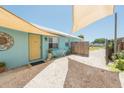 Charming cottage-style home featuring a bright exterior, cozy courtyard, and a welcoming entrance at 139 Randle Ave, Oak Hill, FL 32759