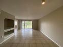 Bright living room with tile flooring, slider to patio, and neutral paint at 14025 Fairway Island Dr # 335, Orlando, FL 32837