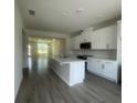 Bright kitchen with stainless appliances, tile backsplash and large center island at 1407 Mount Royal Dr, St Cloud, FL 34771