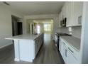 Modern kitchen with white cabinets, stainless steel appliances, and an island at 1407 Mount Royal Dr, St Cloud, FL 34771
